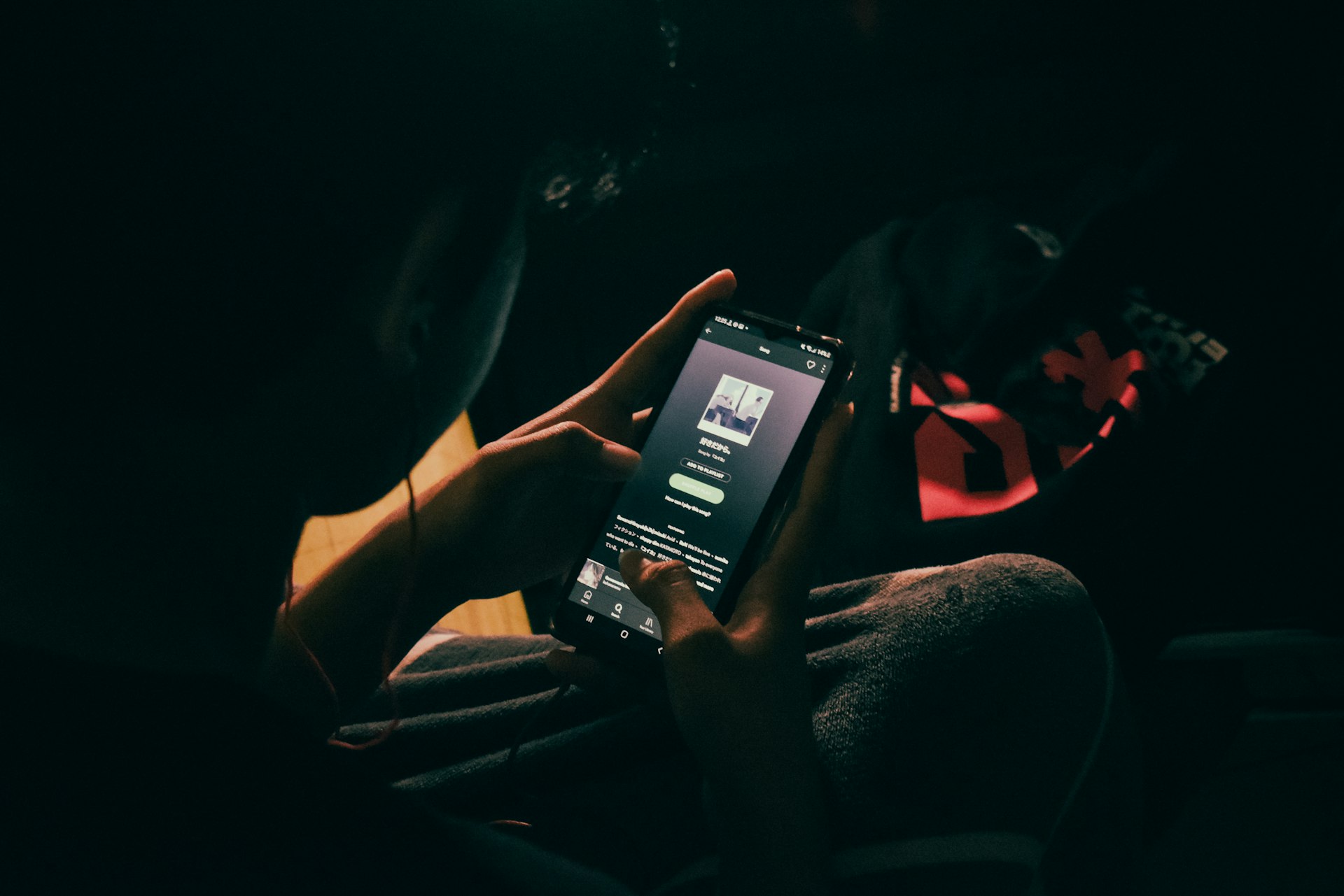 a person holding a cell phone in their hand
